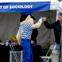 Louie fistbumps an alum at Reunion Row